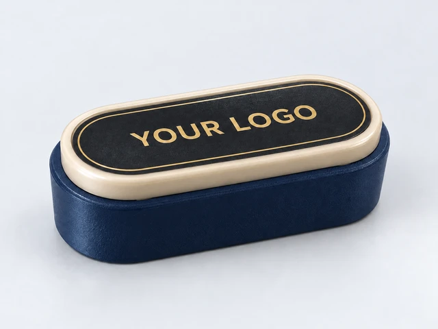 Illustrative midnight-blue button body with champagne-coloured frame and gold YOUR LOGO artwork
